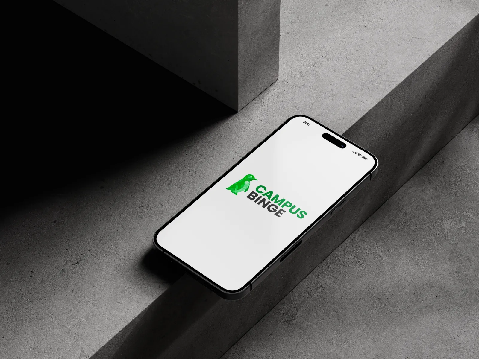 A phone on concrete showing the Campus Binge logo